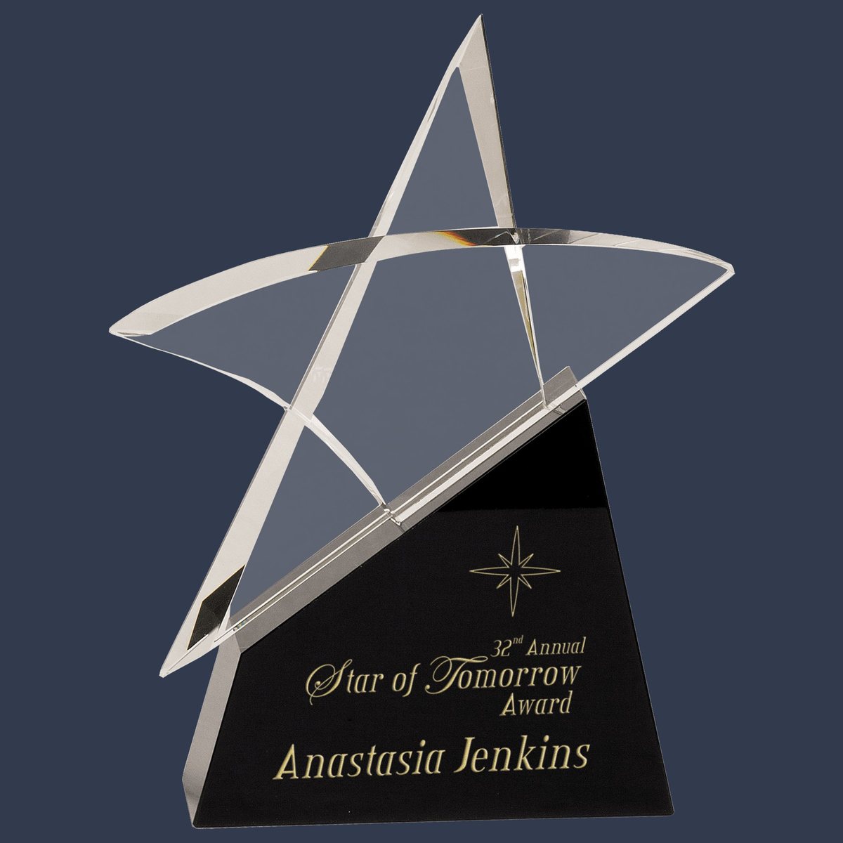 A crystal star award on a black base, engraved with a starburst, the award title and the recipient's name.