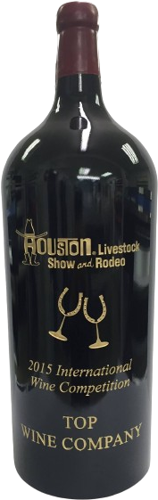 A tall etched magnum carrying the Houston Livestock Show and Rodeo mark in gold, above two horseshoe-stemmed wine glasses and the words 2015 International Wine Competition, Top Wine Company.