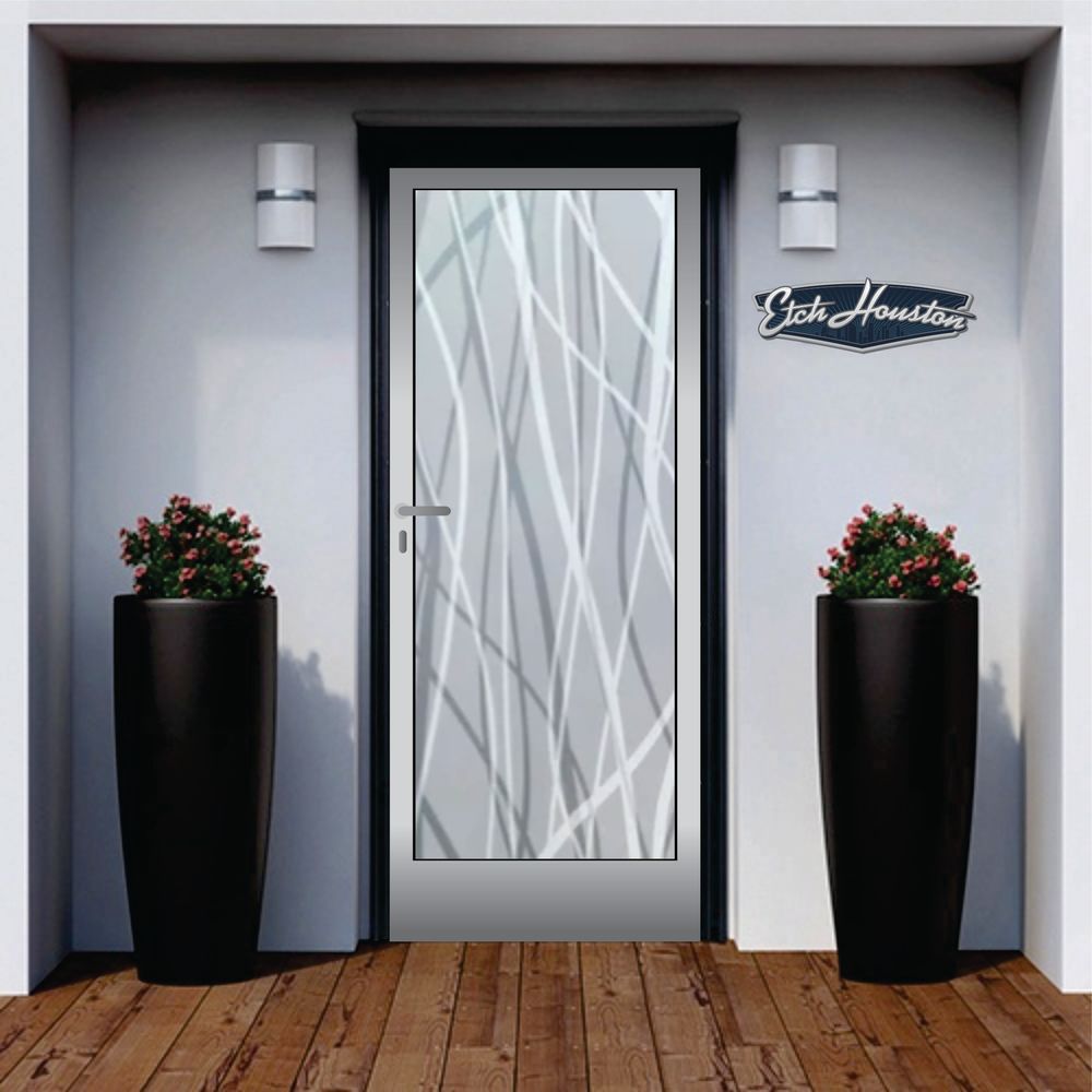An entrance door with a decorative glass panel carrying flowing, reed-like strands, between two tall black planters.