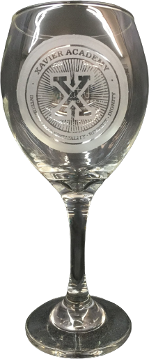 A stemmed wine glass etched with a circular Xavier Academy crest.