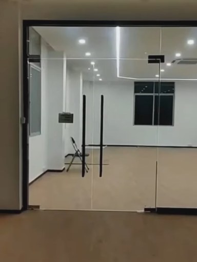 The same partition powered on and completely clear, showing the meeting room, its windows and the floor beyond.